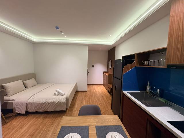 The apartment: a double bed, a dining table and a kitchen